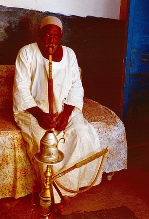 Egyptian smoking a water pipe.