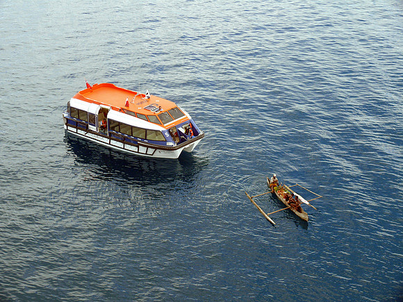 Fruit vendor in canoe.