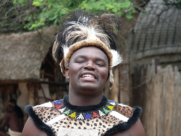Zulu warrior smiling  as he greets visitors.