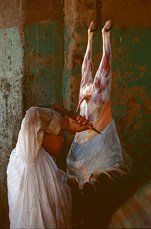 Skinning a goat for market.