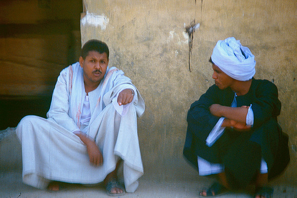 Two Egyptians rest in the shade.